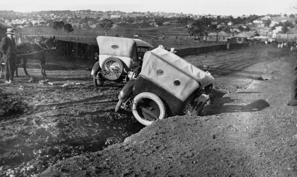 Old-timey car stuck in a rut
